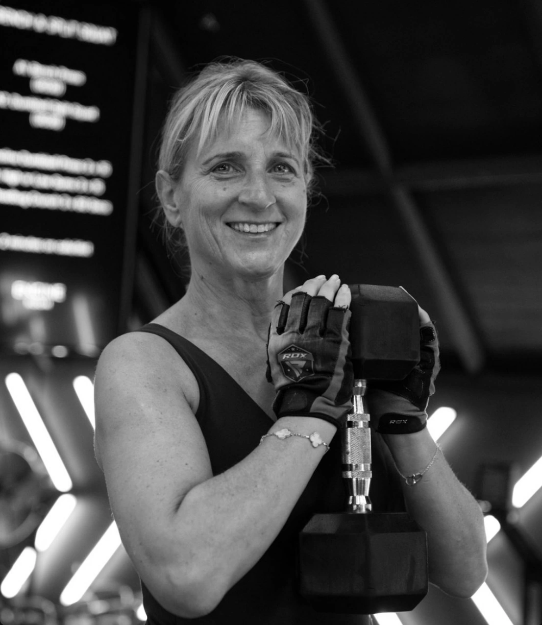 An Engine Room member holding a dumbbell during strength training