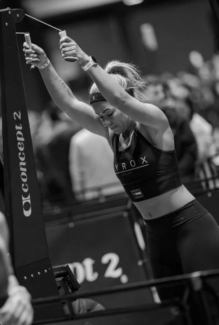 An athlete using the SkiErg at a HYROX event